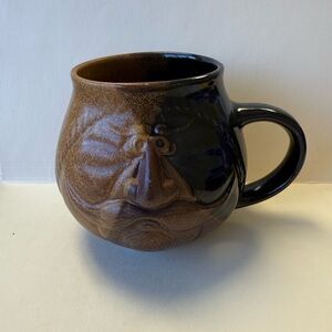 Vintage Craft Mug With Mustached Face On Cup, Color From Dark To Light Brown.